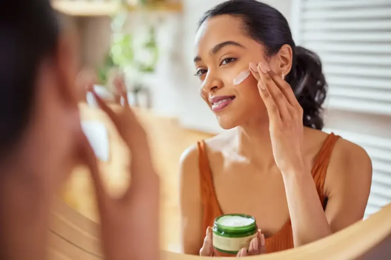 Woman applying anti-aging face cream in morning skincare routine